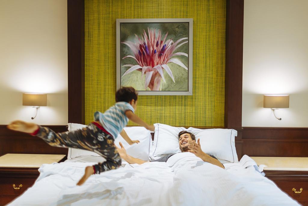 Occidental At Xcaret Destination Hotel Playa del Carmen Bagian luar foto A child jumps on a bed.